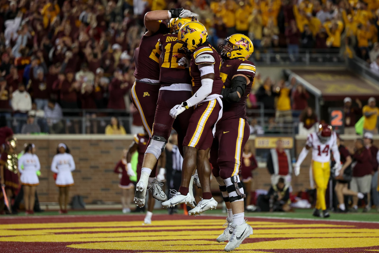 Minnesota celebrates a touchdown by quarterback Max Brosmer (16) during the second half of an NCAA college football game against Southern California, Saturday, Oct. 5, 2024, in Minneapolis. (AP Photo/Ellen Schmidt)