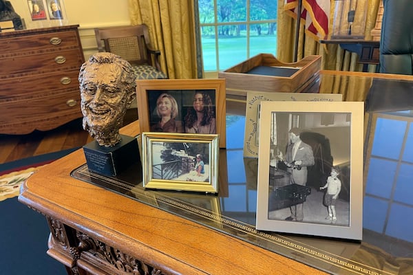 Photos and a bust of Franklin D. Roosevelt are displayed on a replica of the Resolute desk at the Clinton Presidential Library and Museum in Little Rock, Ark., Tuesday, Nov. 12, 2024. (AP Photo/Andrew DeMillo)