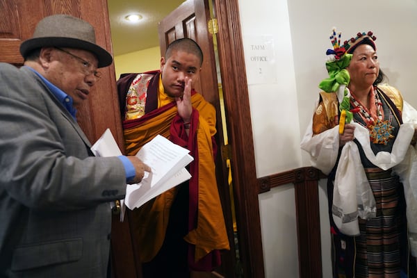 U.S.-born Buddhist lama, Jalue Dorje, center, calls for his dad before making an entrance at his 18th birthday and enthronement ceremony in Isanti, Minn., on Saturday, Nov. 9, 2024. (AP Photo/Jessie Wardarski)