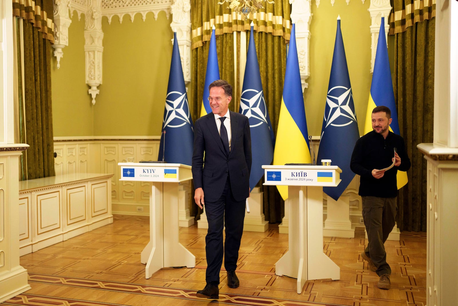 NATO Secretary General Mark Rutte, left, and Ukrainian President Volodymyr Zelenskyy leave the hall after a joint press conference in Kyiv, Ukraine, Thursday Oct. 3, 2024. (AP Photo/Evgeniy Maloletka)