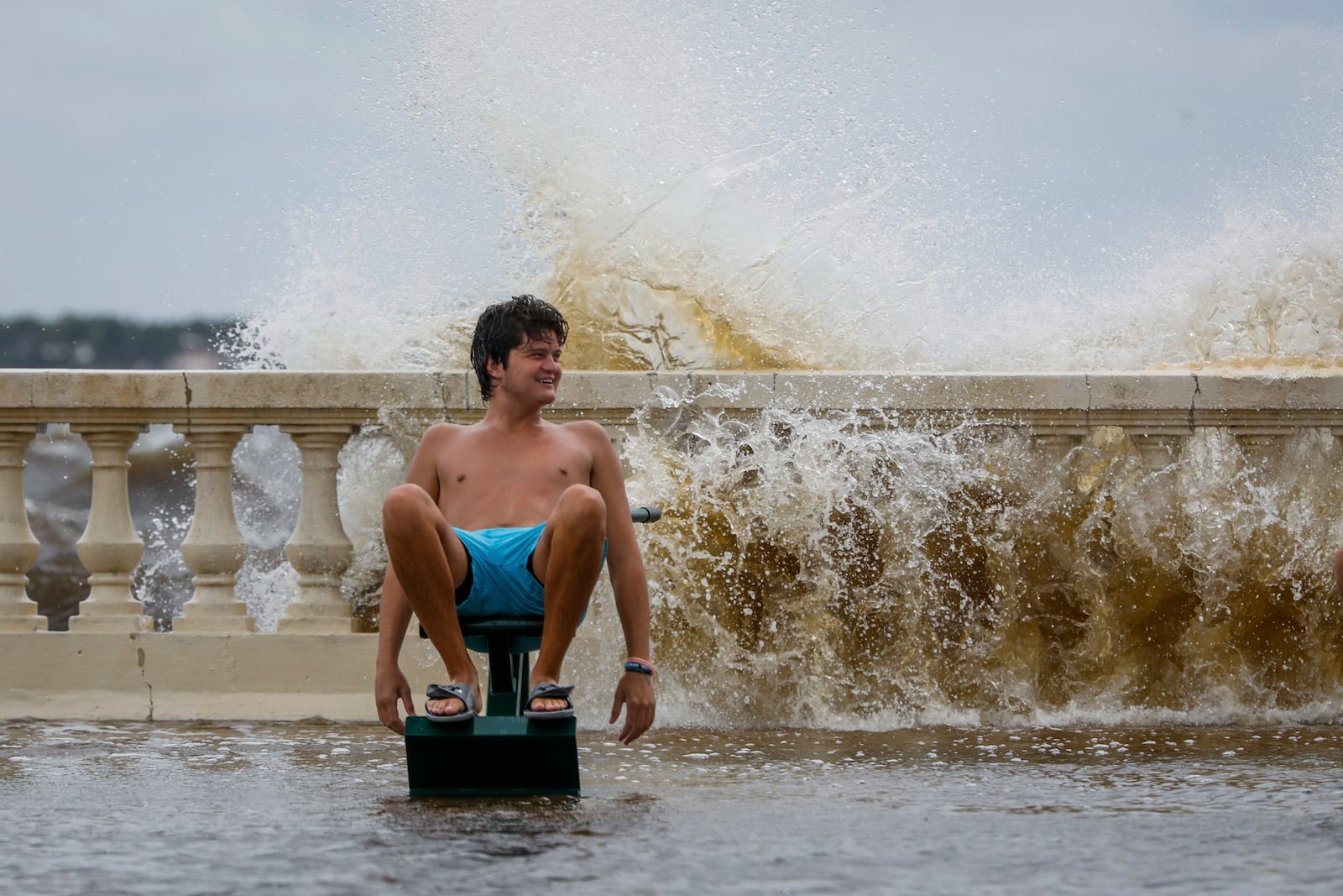 A man reacts while a wave comes from behind along Bayshore Boulevard on Thursday, Sept. 26, 2024, in Tampa, Fla. (Jefferee Woo/Tampa Bay Times via AP)