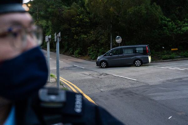 Vehicles believed to be carrying former pro-democracy lawmaker Gary Fan, who was released after four years for his conviction under the national security law, leaves the Shek Pik Prison in Hong Kong, Tuesday, April 29, 2025. (AP Photo/Chan Long Hei)