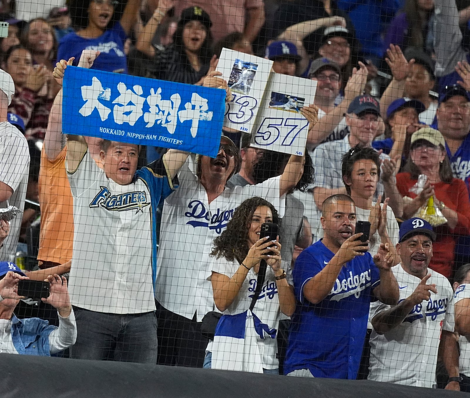 Fans celebrate as Los Angeles Dodgers' Shohei Ohtani circles the bases after hitting a three-run home run off Colorado Rockies relief pitcher Anthony Molina in the sixth inning of a baseball game Friday, Sept. 27, 2024, in Denver. (AP Photo/David Zalubowski)