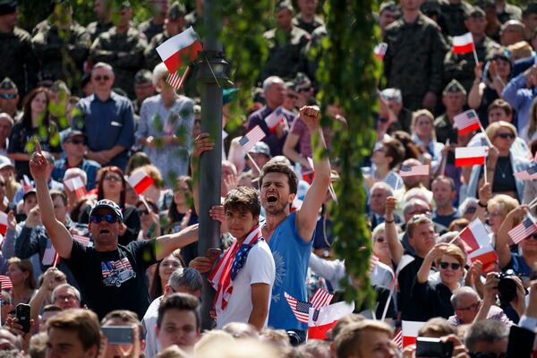 FILE - People cheer as US President Donald Trump delivers a speech at Krasinski Square at the Royal Castle, July 6, 2017, in Warsaw. (AP Photo/Evan Vucci, File)