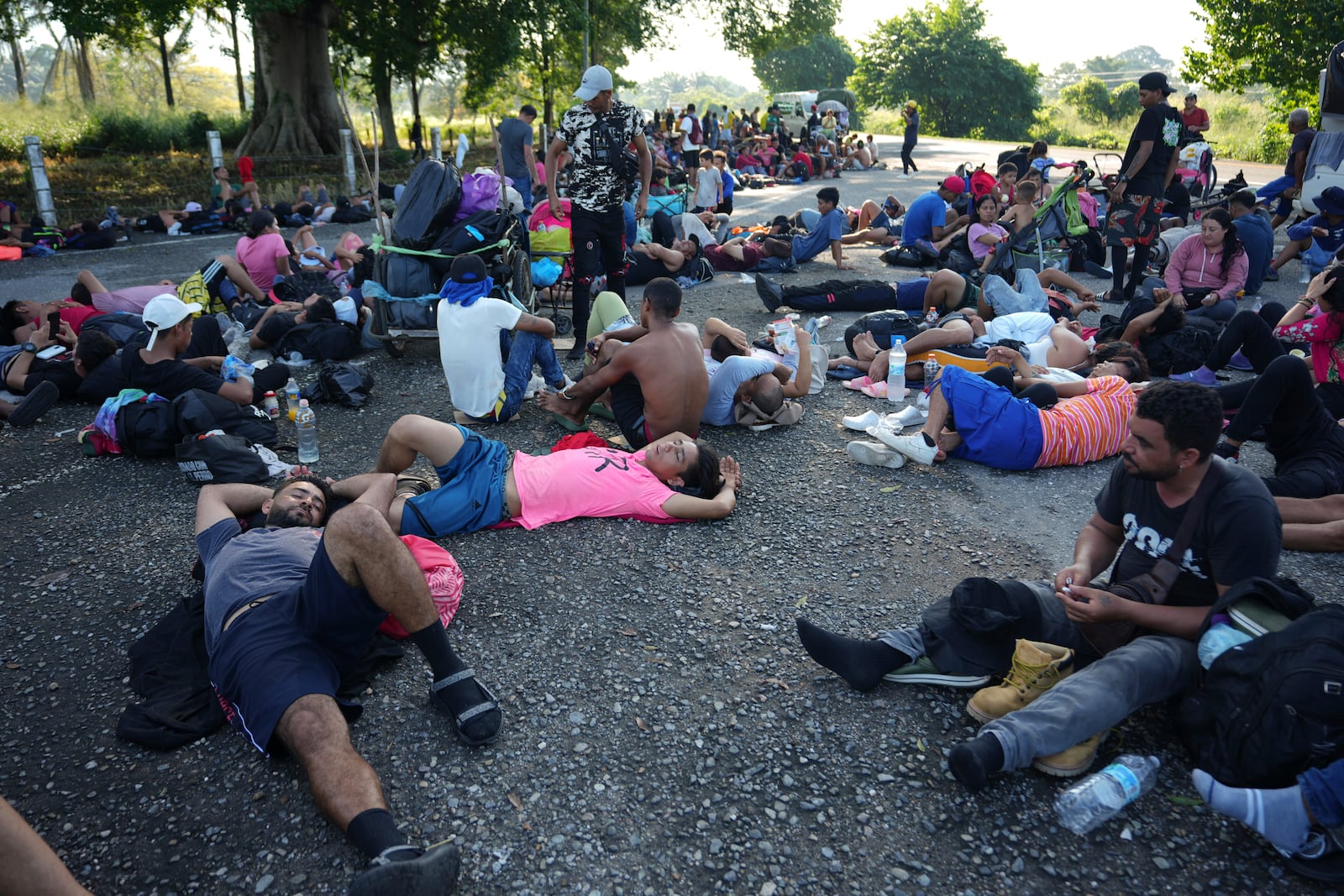 Migrants, who are part of a caravan heading toward the country's northern border and ultimately the United States, rest on the outskirts of Escuintla, southern Mexico, Thursday, Nov. 7, 2024. (AP Photo/Moises Castillo)