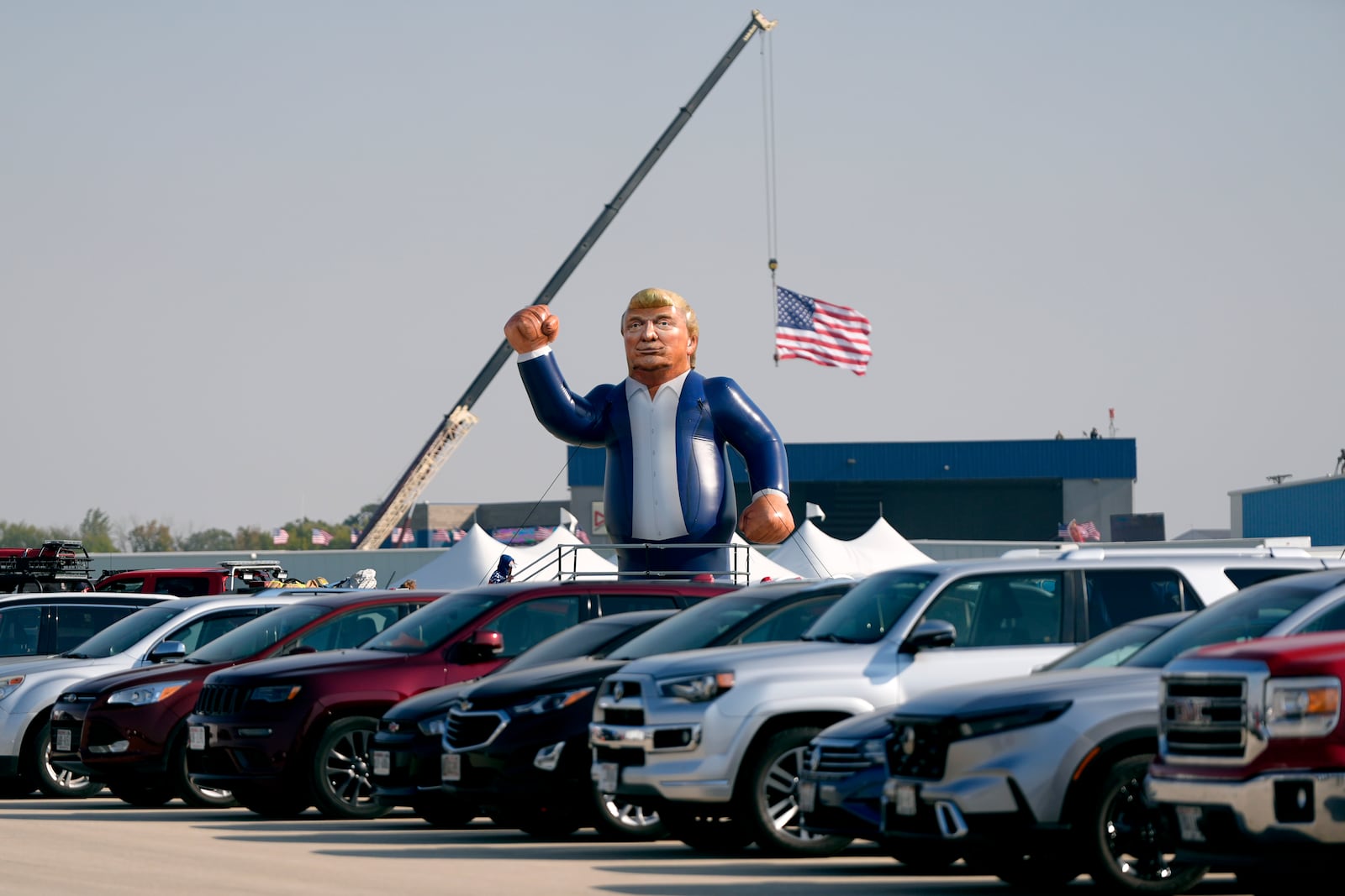 An inflatable Donald Trump is pictured in the parking lot of a campaign rally before the Republican presidential nominee former President arrives to speak at Dodge County Airport, Sunday, Oct. 6, 2024, in Juneau, Wis. (AP Photo/Julia Demaree Nikhinson)