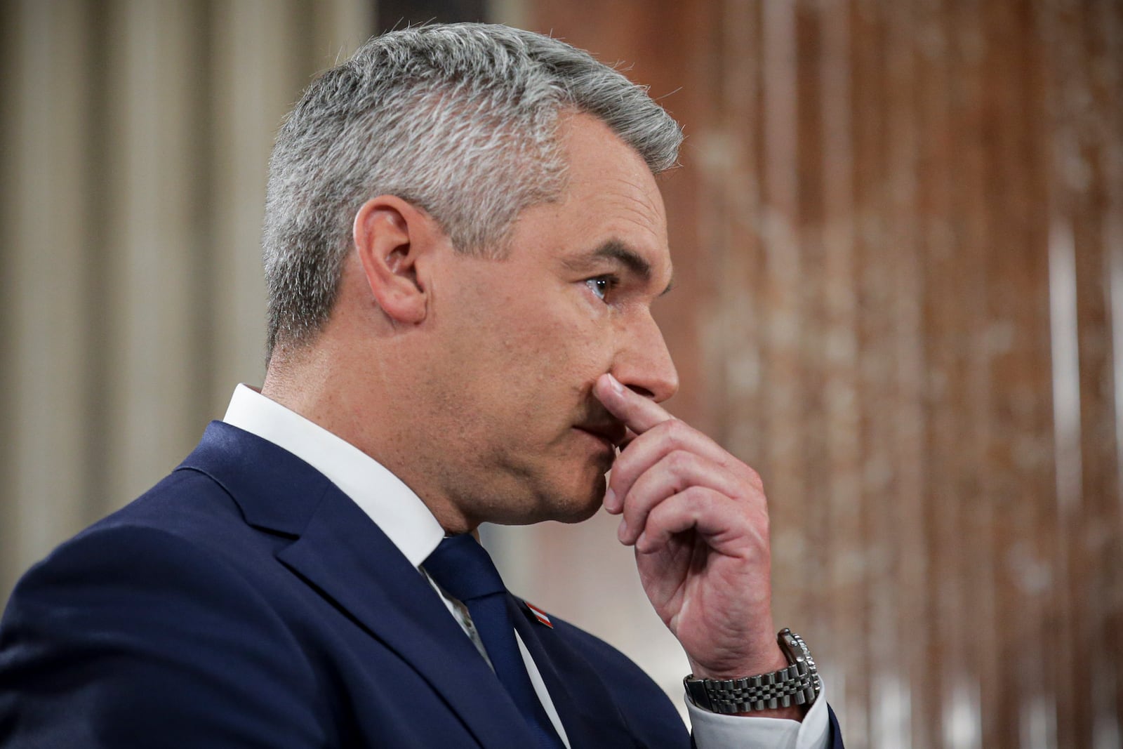 Austrian Chancellor Karl Nehammer gestures at the national broadcaster studio, set up in the parliament building, in Vienna, Austria, Sunday, Sept. 29, 2024, after polls closed in the country's national election. (AP Photo/Heinz-Peter Bader)