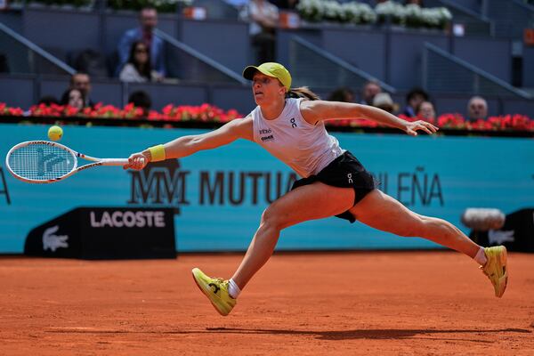 Iga Swiatek of Poland returns the ball against Russia's Diana Shnaider during the Madrid Open tennis tournament in Madrid, Spain, Tuesday, April 29, 2025. (AP Photo/Manu Fernandez)
