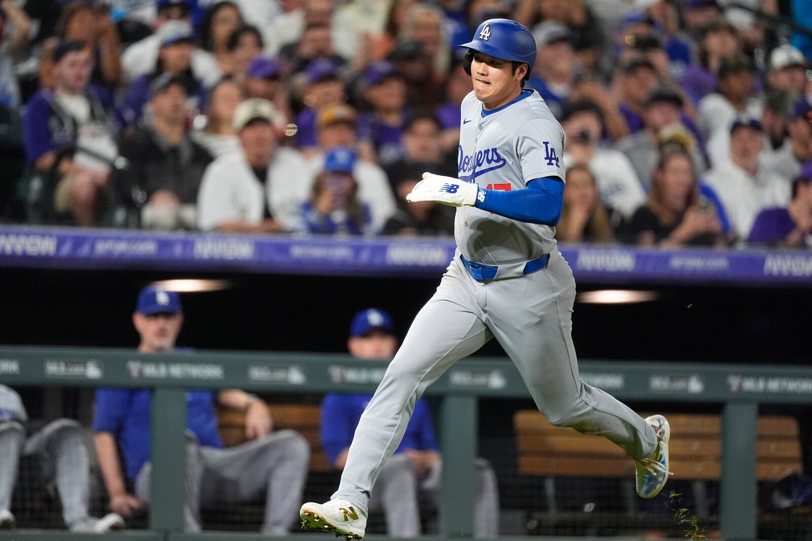 Los Angeles Dodgers' Shohei Ohtani scores on a double hit by Kevin Kiermaier off Colorado Rockies relief pitcher Luis Peralta in the eighth inning of a baseball game Friday, Sept. 27, 2024, in Denver. (AP Photo/David Zalubowski)