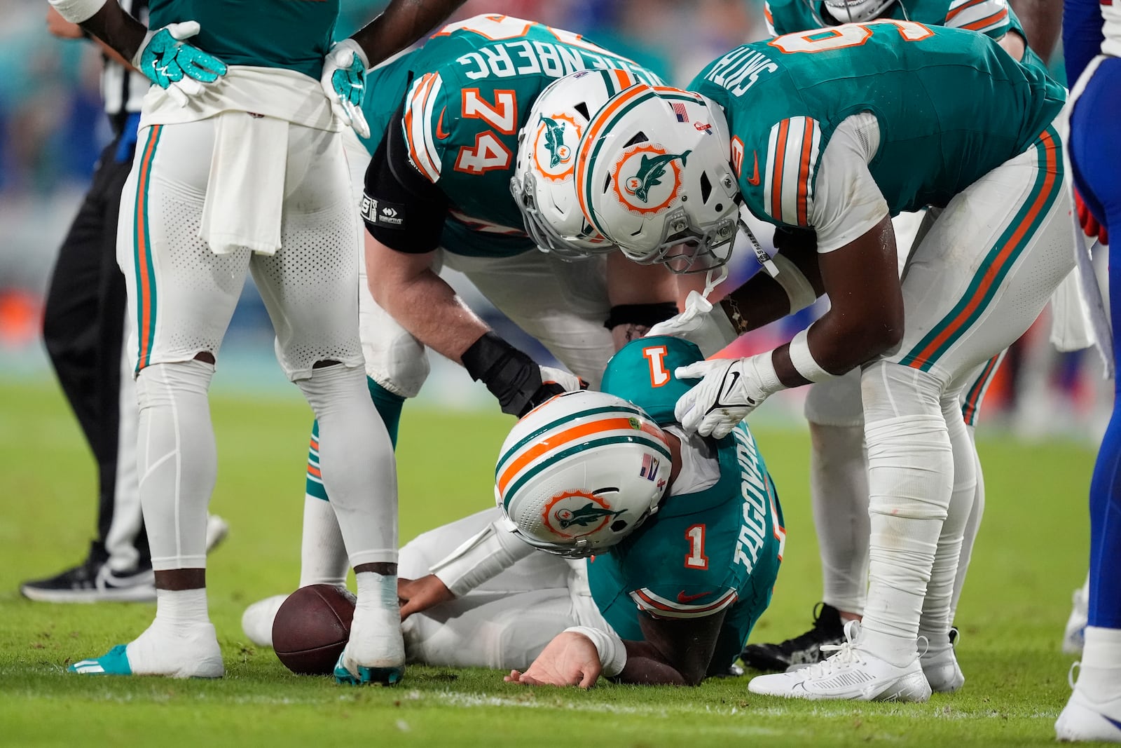 Miami Dolphins quarterback Tua Tagovailoa (1) lies on the field after suffering a concussion during the second half of an NFL football game against the Buffalo Bills, Thursday, Sept. 12, 2024, in Miami Gardens, Fla. (AP Photo/Rebecca Blackwell)