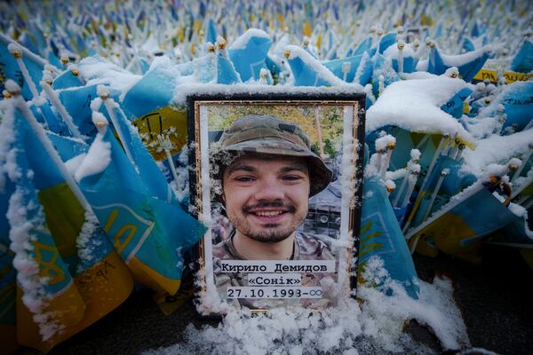 Snow coats the photograph of a fallen Ukrainian serviceman in Independence Square in Kyiv, Ukraine Tuesday, March 12, 2024. (AP Photo/Vadim Ghirda)