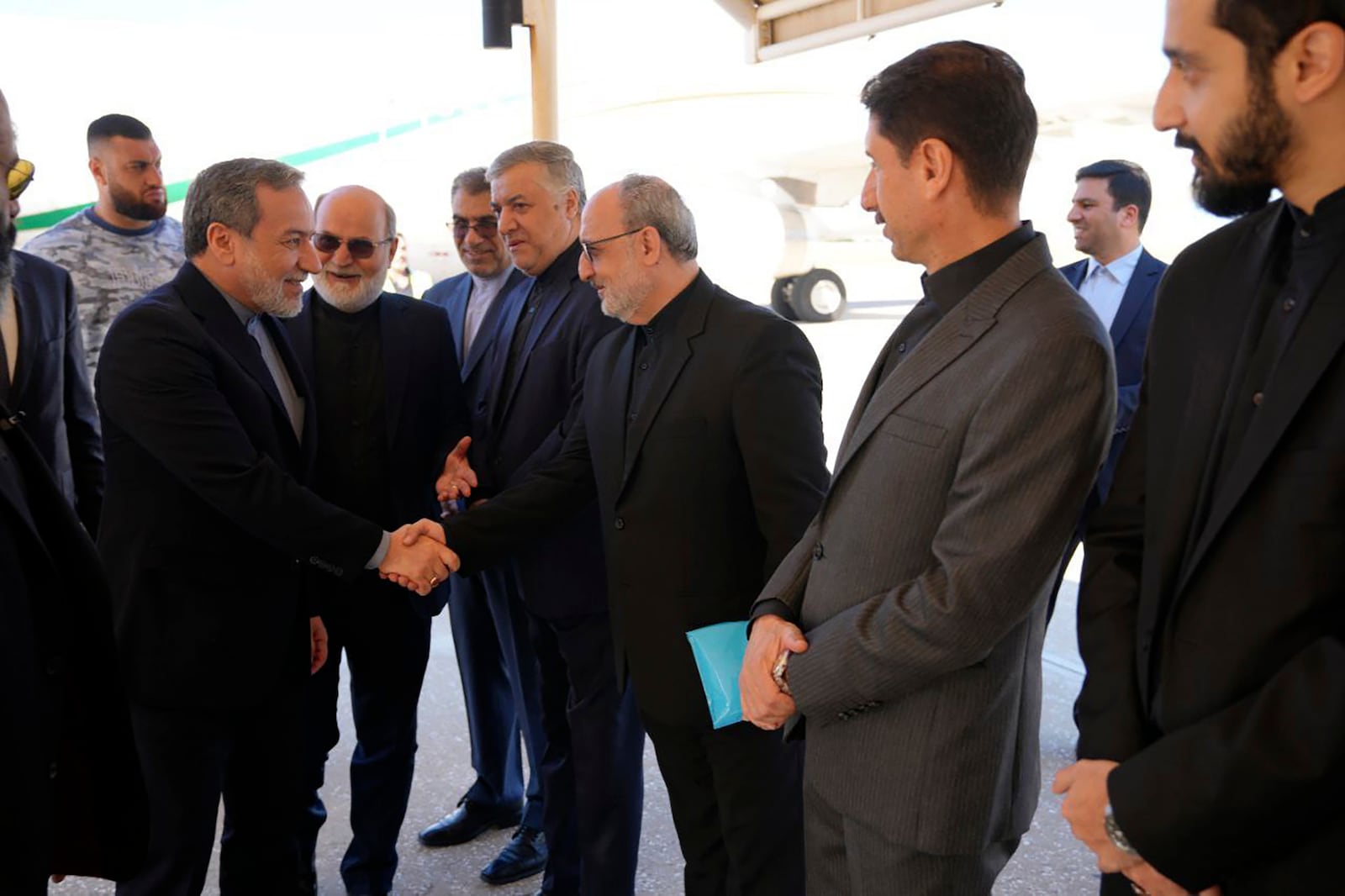 In this photo released by Iranian Foreign Ministry, Foreign Minister Abbas Araghchi, left, is welcomed by a group of officials upon arrival at Beirut, Lebanon, Friday, Oct. 4, 2024. (Iranian Foreign Ministry via AP)