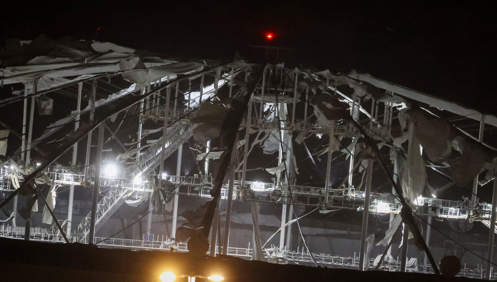 The roof of Tropicana Field, the home of the Tampa Bay Rays, appeared to be badly damaged as Hurricane Milton passes Thursday, Oct. 10, 2024, in St. Petersburg, Fla. (Chris Urso/Tampa Bay Times via AP)