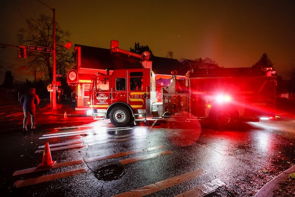 A firetruck blocks NE 80th St. at Roosevelt after power lines fell across the street during a major storm Tuesday, Nov. 19, 2024 in Seattle. (Jennifer Buchanan/The Seattle Times via AP)