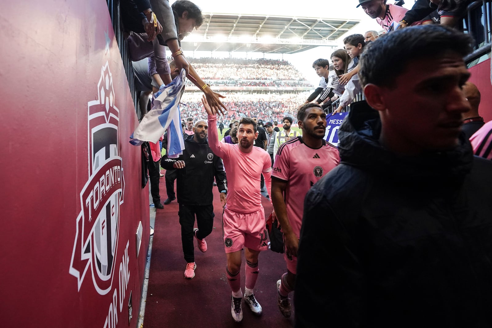 Inter Miami's Lionel Messi greets a fan as he comes off the field after his team's 1-0 win over Toronto FC in an MLS soccer match in Toronto Saturday, Oct. 5, 2024. (Chris Young/The Canadian Press via AP)