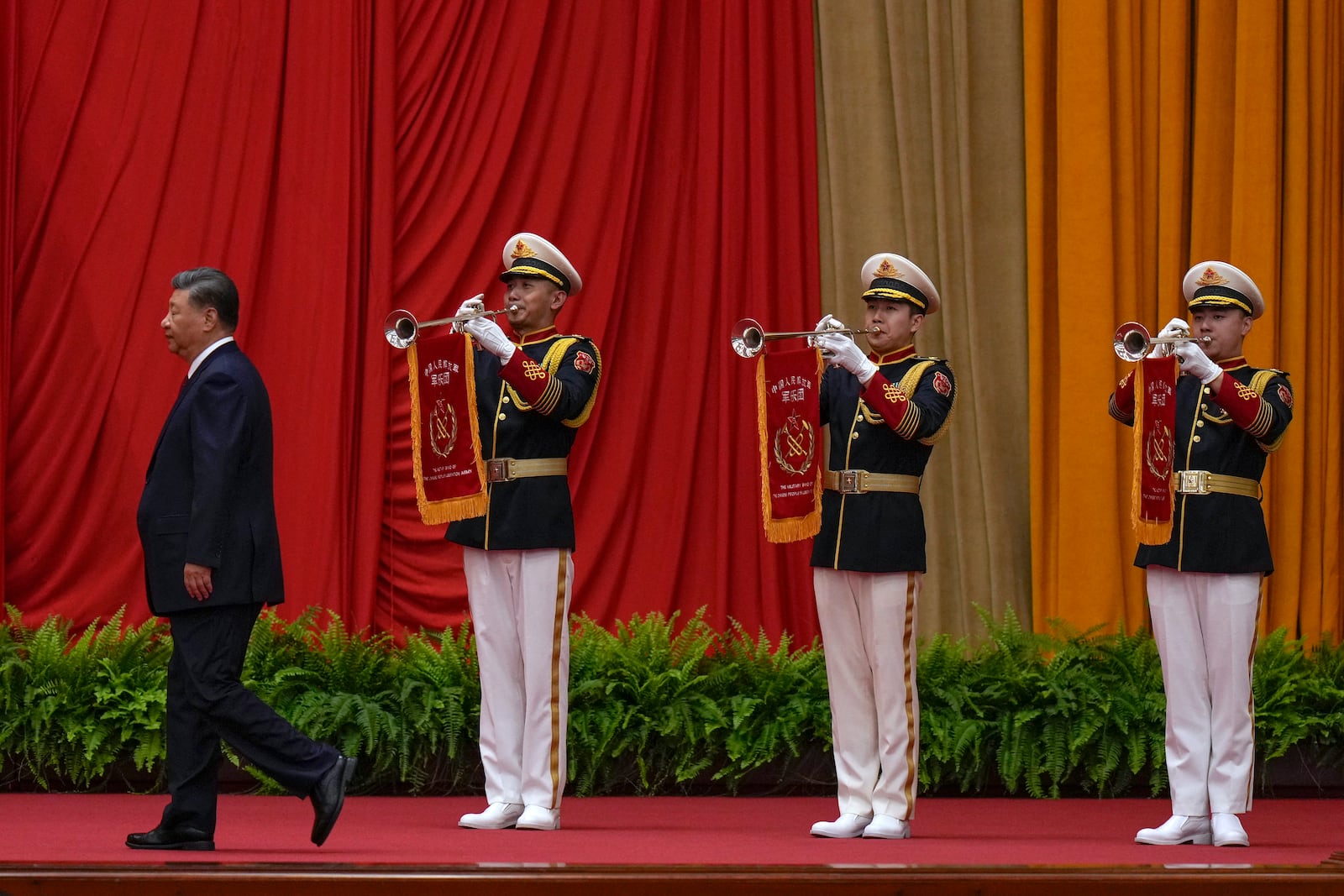 Chinese President Xi Jinping walks past a music band as he is on his way to deliver his speech at a dinner marking the 75th anniversary of the founding of the People's Republic of China, at the Great Hall of the People in Beijing, Monday, Sept. 30, 2024. (AP Photo/Andy Wong)