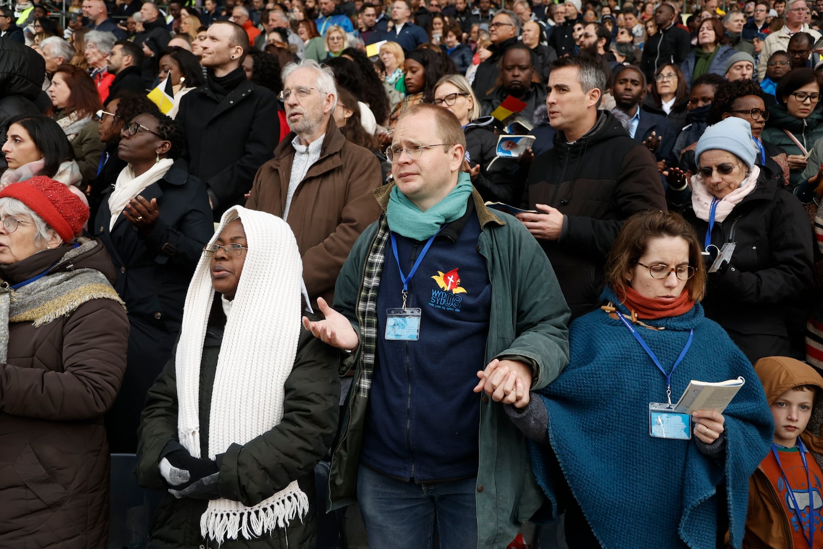 Faithful listen as Pope Francis presides the holy mass , at the King Baudouin stadium in Brussels, Belgium, Sunday, Sept. 29, 2024. (AP Photo/Omar Havana)