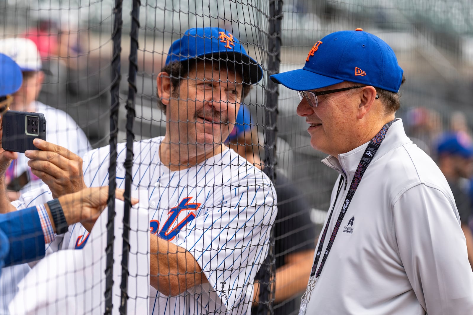 New York Mets owner Steve Cohen, right, poses with a fan for a photo before the start of a baseball game against the Atlanta Braves, Monday, Sept. 30, 2024, in Atlanta. (AP Photo/Jason Allen)