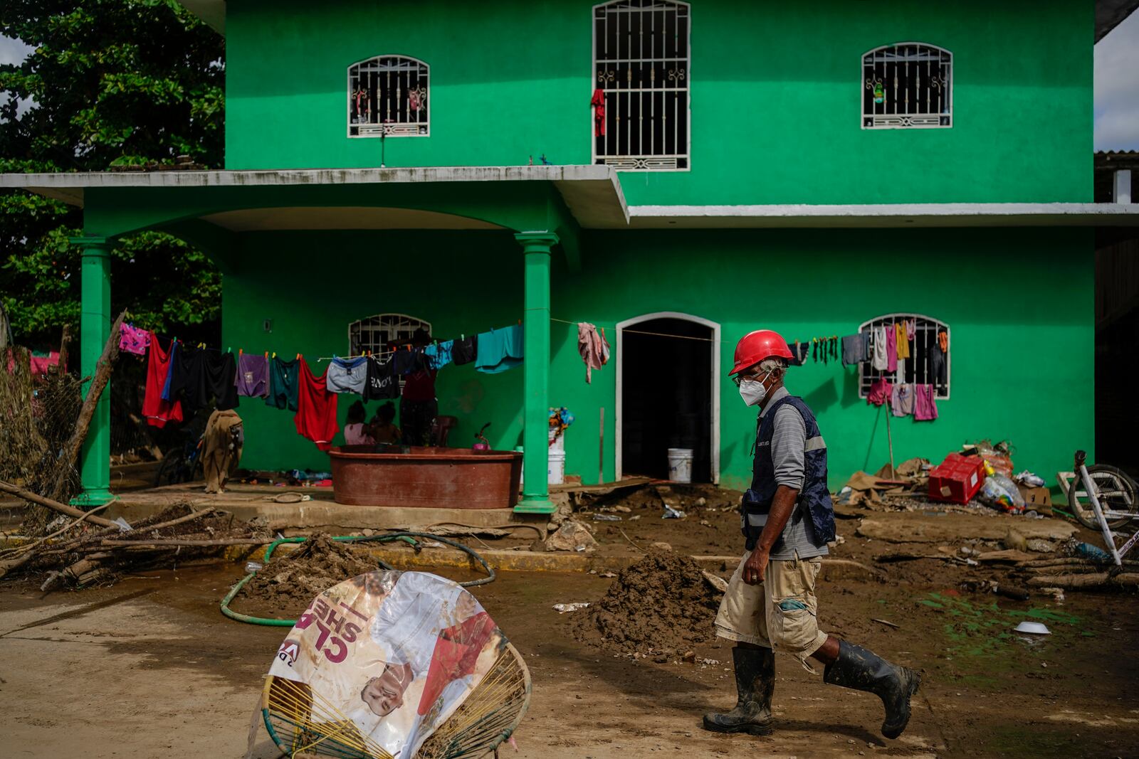 A volunteer inspects the damage in Coyuca de Benitez, Guerrero state, Mexico, after Hurricane John passed through, Monday, Sept. 30, 2024. (AP Photo/Felix Marquez)