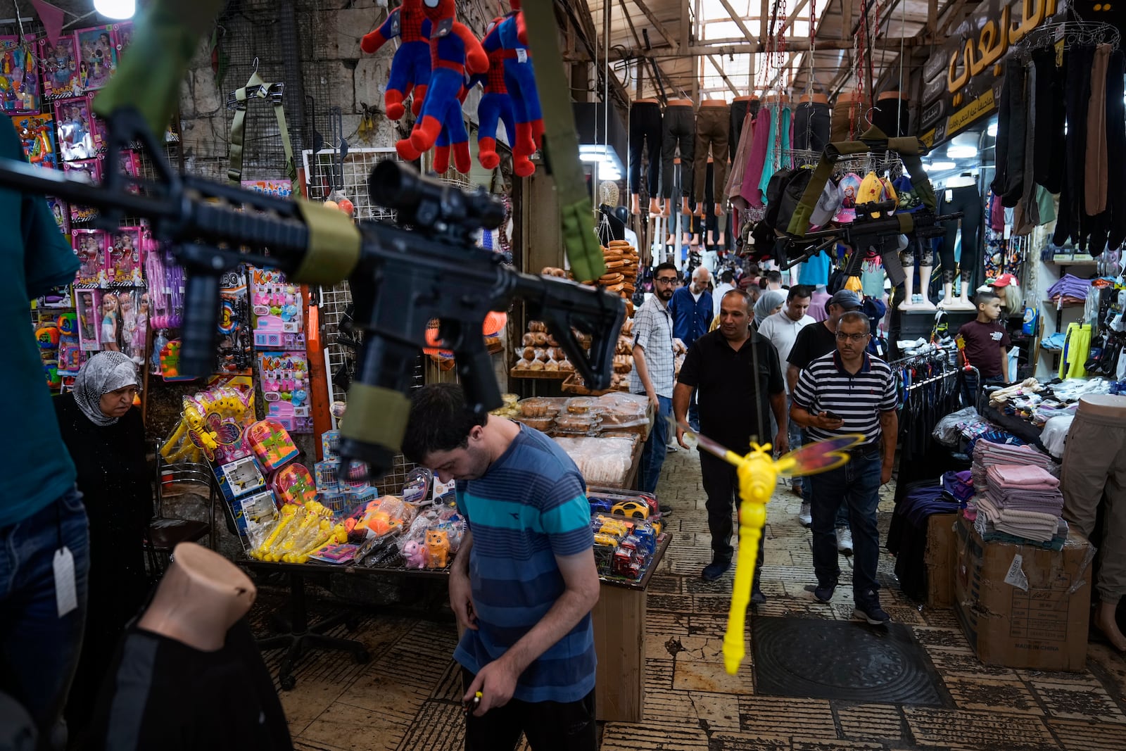 Palestinians shop at the commercial center of the old town, in the West Bank city of Nablus Sunday, Sept. 15, 2024. (AP Photo/Majdi Mohammed)