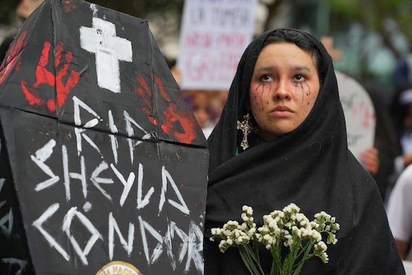 Ariana Campos takes part in a march marking the upcoming International Day for the Elimination of Violence Against Women, in Lima, Peru, Saturday, Nov. 23, 2024. (AP Photo/Guadalupe Pardo)