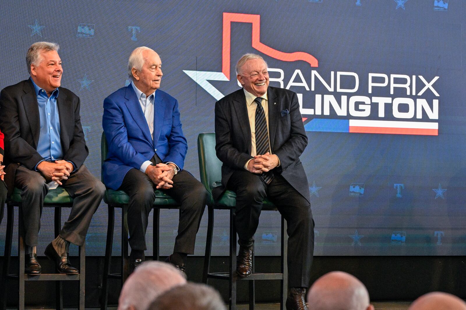 Texas Rangers chief operating officer Neil Leibman, left, IndyCar owner Roger Penske, center, and Dallas Cowboys team owner Jerry Jones look on during a news conference announcing the IndyCar Grand Prix of Arlington to be held in 2026 in Arlington, Texas, Tuesday, Oct. 8, 2024. (AP Photo/Jerome Miron)