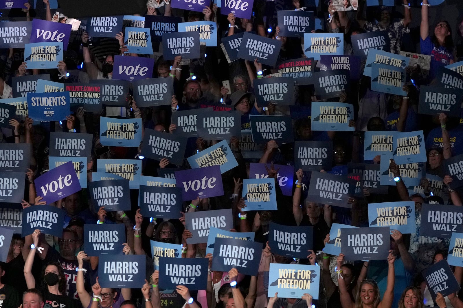 Attendees hold up signs before Democratic presidential nominee Vice President Kamala Harris arrives to speak during a campaign event at East Carolina University, Sunday, Oct. 13, 2024, in Greenville, N.C. (AP Photo/David Yeazell)