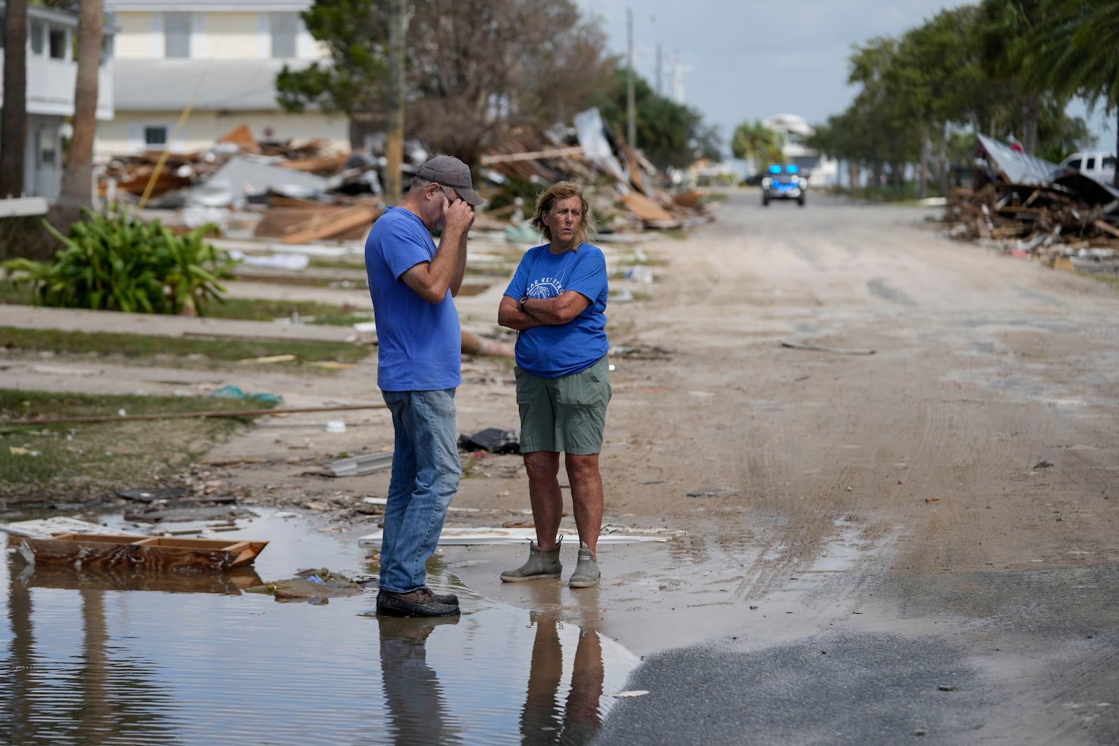 Leslie Sturmer, a University of Florida employee, and John Rittenhouse, general manager of the Cedar Key Water and Sewer District, both residents, talk in the aftermath of Hurricane Helene, in Cedar Key, Fla., Friday, Sept. 27, 2024. (AP Photo/Gerald Herbert)