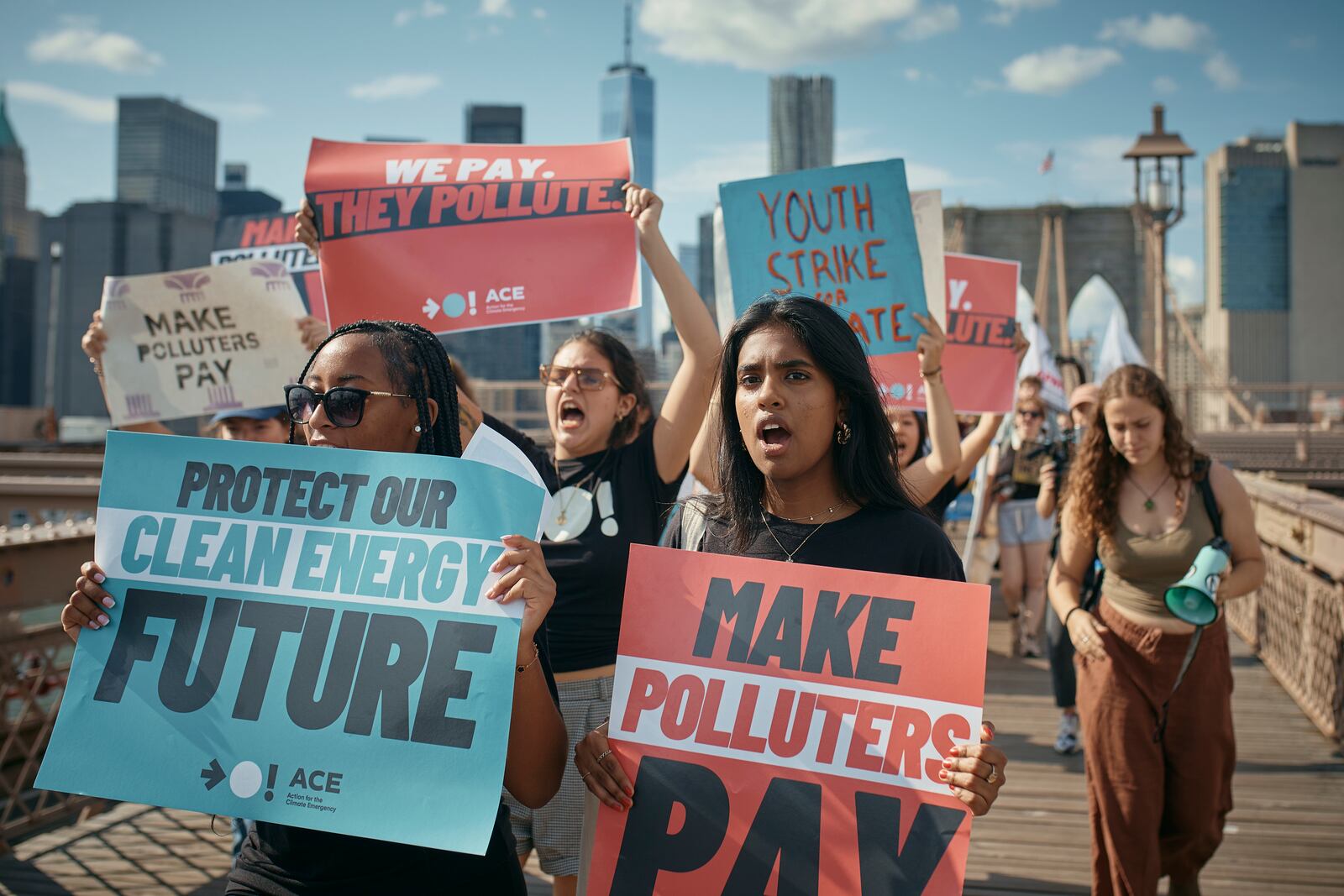 Protesters shout slogans as they cross the Brooklyn Bridge during a Youth Climate Strike march to demand an end to the era of fossil fuels, Friday, Sept. 20, 2024, in New York. (AP Photo/Andres Kudacki)