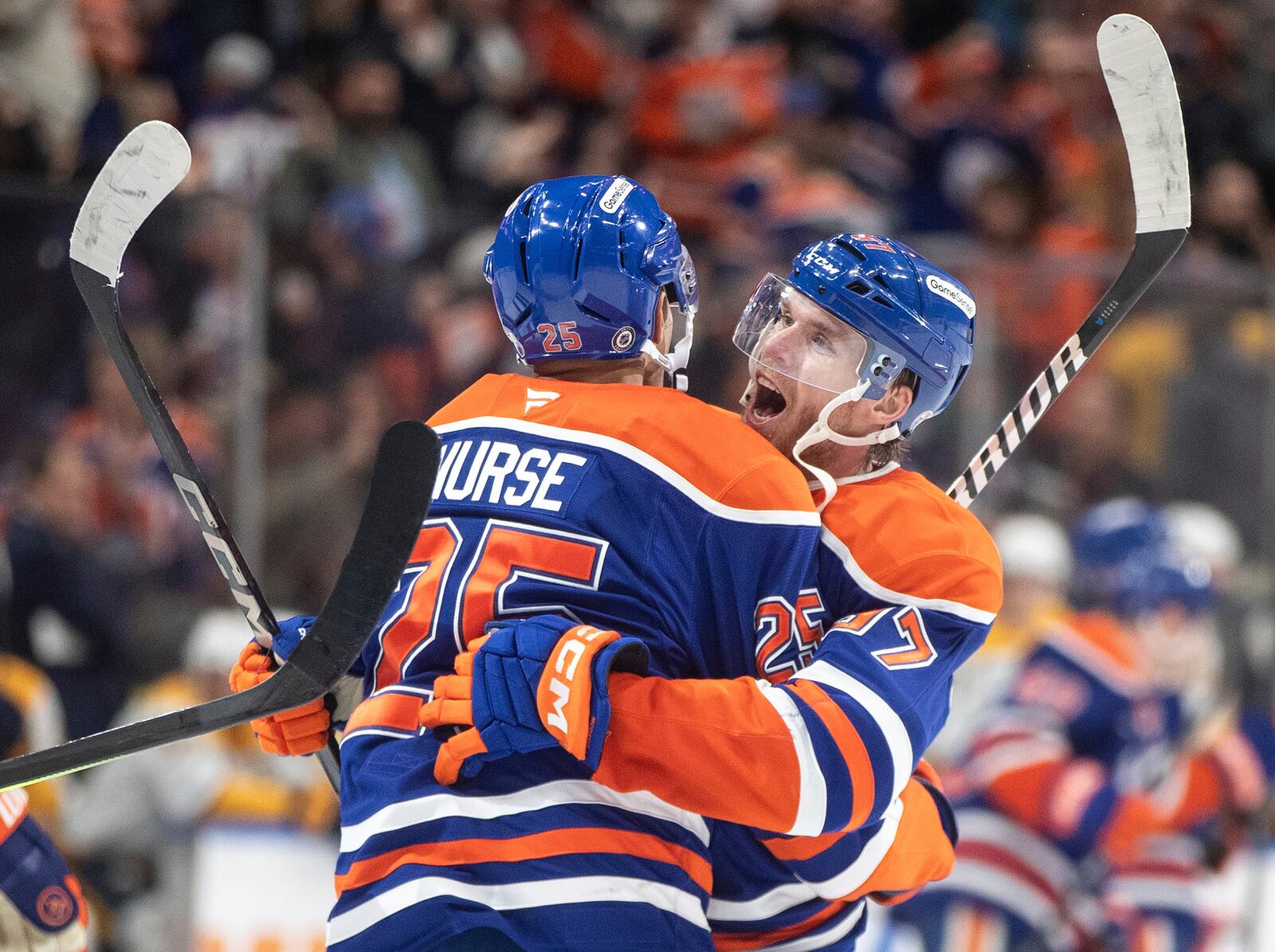 Edmonton Oilers' Darnell Nurse (25) and Connor McDavid (97) celebrate after their win over the Nashville Predators during overtime NHL hockey game action in Edmonton, Alberta, Thursday, Nov. 14, 2024. (Jason Franson/The Canadian Press via AP)