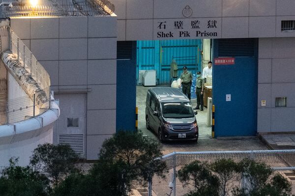 Vehicles believed to be carrying former pro-democracy lawmaker Gary Fan, who was released after four years for his conviction under the national security law, leaves the Shek Pik Prison in Hong Kong, Tuesday, April 29, 2025. (AP Photo/Chan Long Hei)