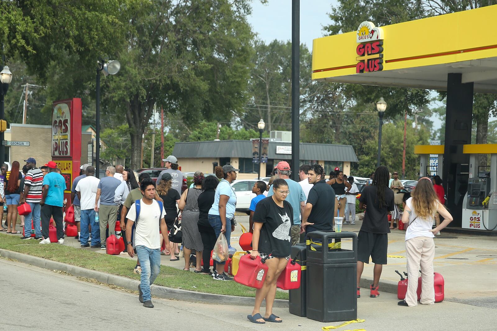 Residents wait in line with gas cans at a Gas Plus gas station in the aftermath of Hurricane Helene Sunday, Sept. 29, 2024, in North Augusta, S.C. (AP Photo/Artie Walker Jr.)