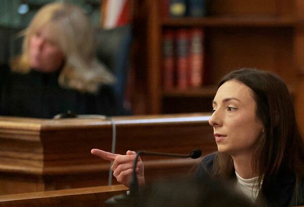 Katie McLaughlin, a paramedic/firefighter with the Canton Fire Department, points to defendant Karen Read, in Dedham, Mass., on Monday, May 5, 2025. (Pat Greenhouse/The Boston Globe via AP, Pool)