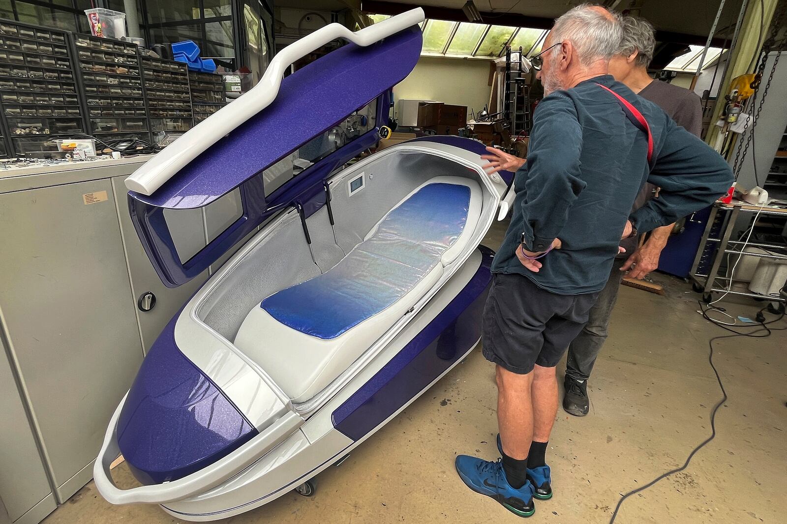 Philip Nitschke, front, stands next to a 'suicide pod' known as 'The Sarco' in Rotterdam, The Netherlands, July 8, 2024. (AP Photo/Ahmad Seir)