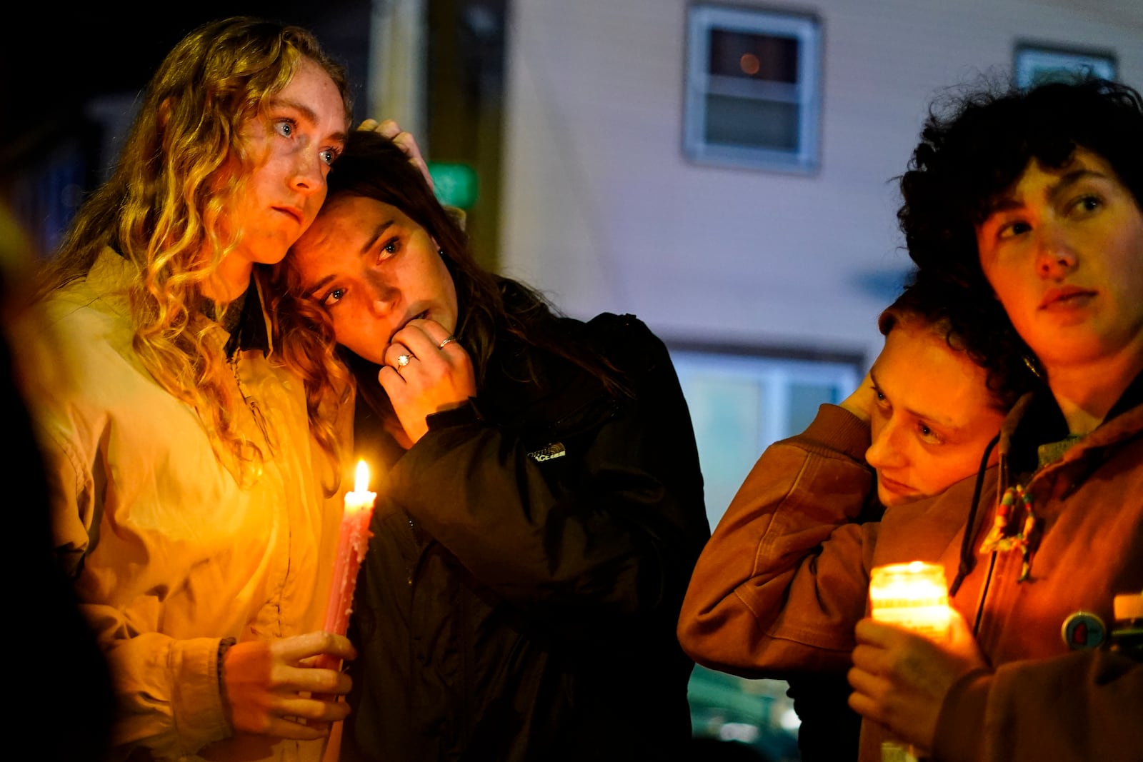 FILE - People linger after a vigil for the victims of Wednesday's mass shootings, Oct. 29, 2023, outside the Basilica of Saints Peter and Paul in Lewiston, Maine. (AP Photo/Matt Rourke, File)