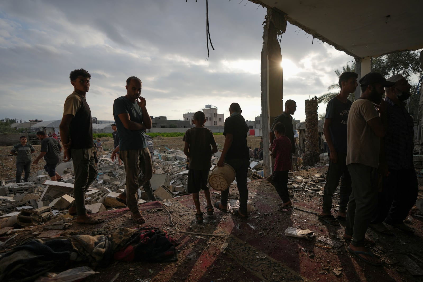 Palestinians examine a destroyed mosque following an Israeli airstrike in Deir al-Balah, Sunday, Oct. 6, 2024. (AP Photo/Abdel Kareem Hana)