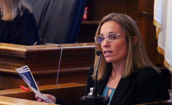 Mass. State Police forensic scientist Maureen Hartnett looks over photo evidence under cross examination at the Karen Read case at Norfolk Superior Court, Wednesday, May 14, 2025, in Dedham, Mass. (Mark Chavous/Enterprise News via AP, Pool)