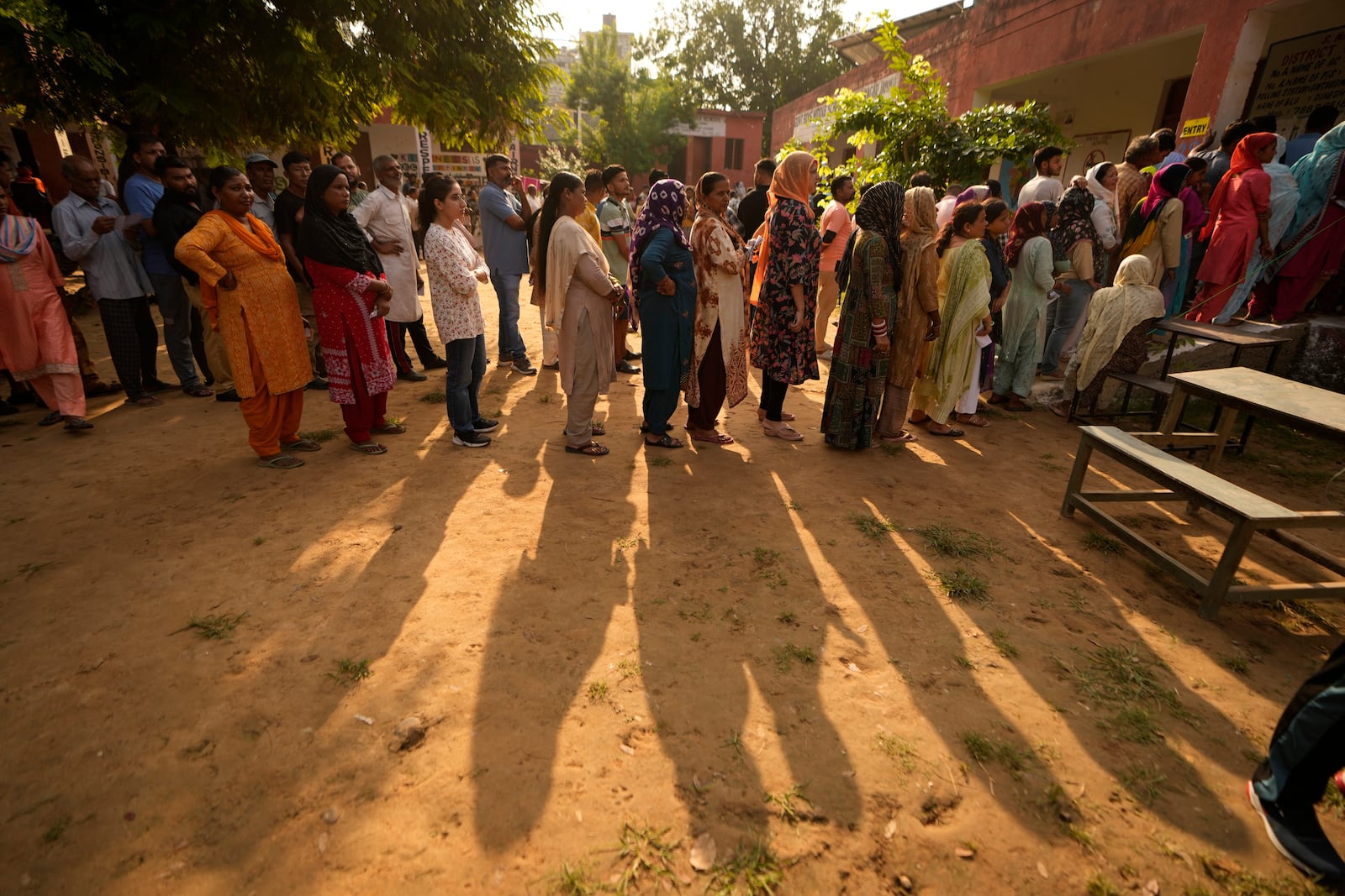 People queue up to cast their vote at a polling booth during the third phase of the Jammu and Kashmir Assembly election in Jammu, India, Tuesday, Oct. 1, 2024. (AP Photos/Channi Anand)