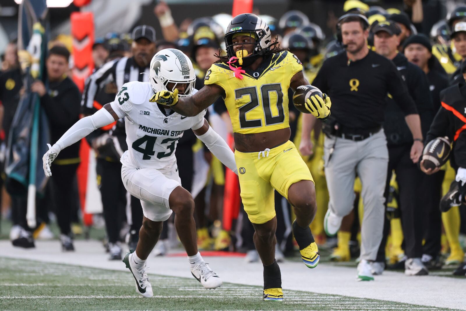 Oregon running back Jordan James (20) runs ahead of Michigan State defensive back Malik Spencer (43) during the first half of an NCAA college football game, Friday, Oct. 4, 2024, in Eugene, Ore. (AP Photo/Amanda Loman)