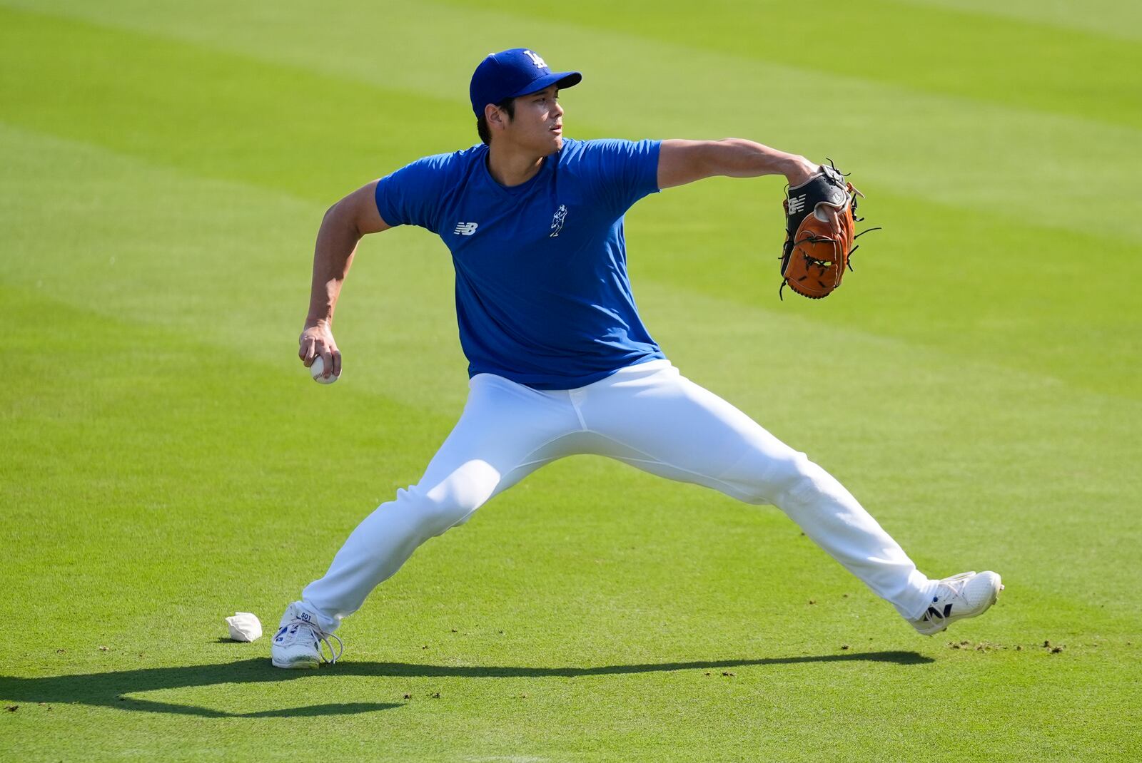 Los Angeles Dodgers' Shohei Ohtani works out before a baseball game against the Colorado Rockies in Los Angeles, Saturday, Sept. 21, 2024. (AP Photo/Ashley Landis)