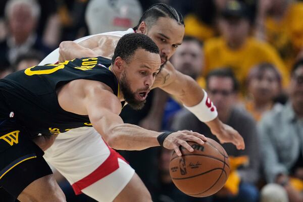 Golden State Warriors guard Stephen Curry, left, takes the ball away from Houston Rockets forward Dillon Brooks during the first half of Game 6 of an NBA basketball first-round playoff series Friday, May 2, 2025, in San Francisco. (AP Photo/Godofredo A. Vásquez)