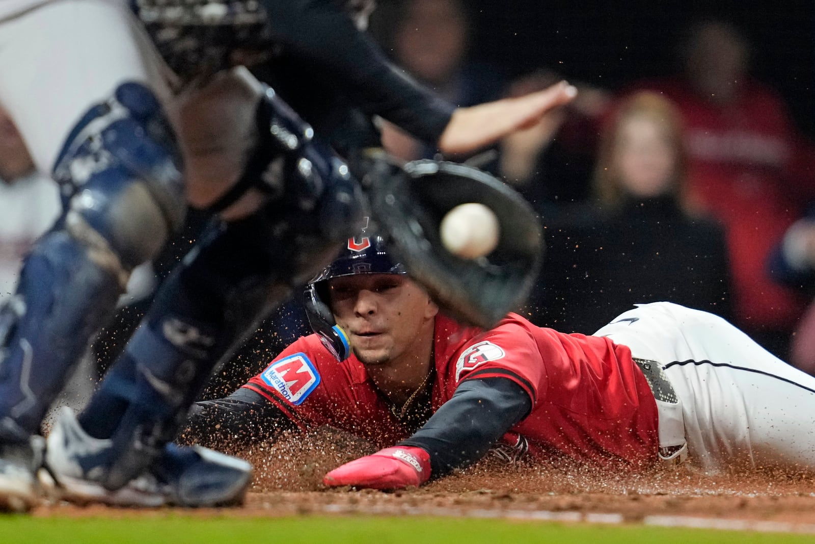 Cleveland Guardians' Andrés Giménez scores as New York Yankees catcher Austin Wells handles the throw at home plate during the fifth inning in Game 5 of the baseball AL Championship Series Saturday, Oct. 19, 2024, in Cleveland. (AP Photo/Godofredo A. Vásquez)