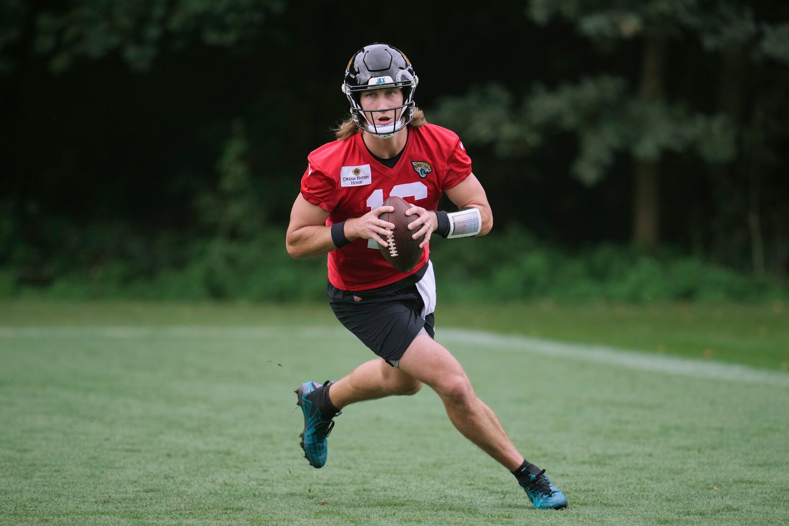 Jacksonville Jaguars NFL football quarterback Trevor Lawrence (16) practices at The Grove in Watford, England, Wednesday, Oct. 16, 2024. (AP Photo/Kin Cheung)