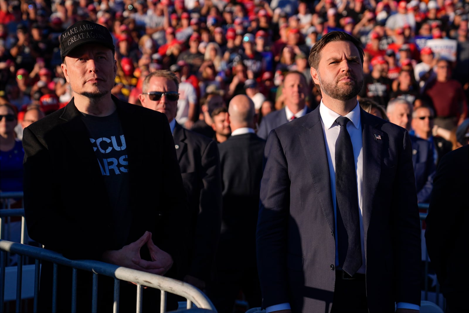 Elon Musk and Republican vice presidential nominee Sen. JD Vance, R-Ohio, listen as Republican presidential nominee former President Donald Trump speaks at a campaign rally at the Butler Farm Show, Saturday, Oct. 5, 2024, in Butler, Pa. (AP Photo/Evan Vucci)