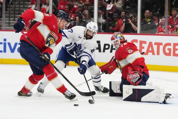 Florida Panthers defenseman Niko Mikkola, left, and Toronto Maple Leafs left wing Max Pacioretty (67) go for the puck as Florida Panthers goaltender Sergei Bobrovsky (72) defends the goal during the second period in Game 6 of a second-round NHL hockey playoff series, Friday, May 16, 2025, in Sunrise, Fla. (AP Photo/Lynne Sladky)