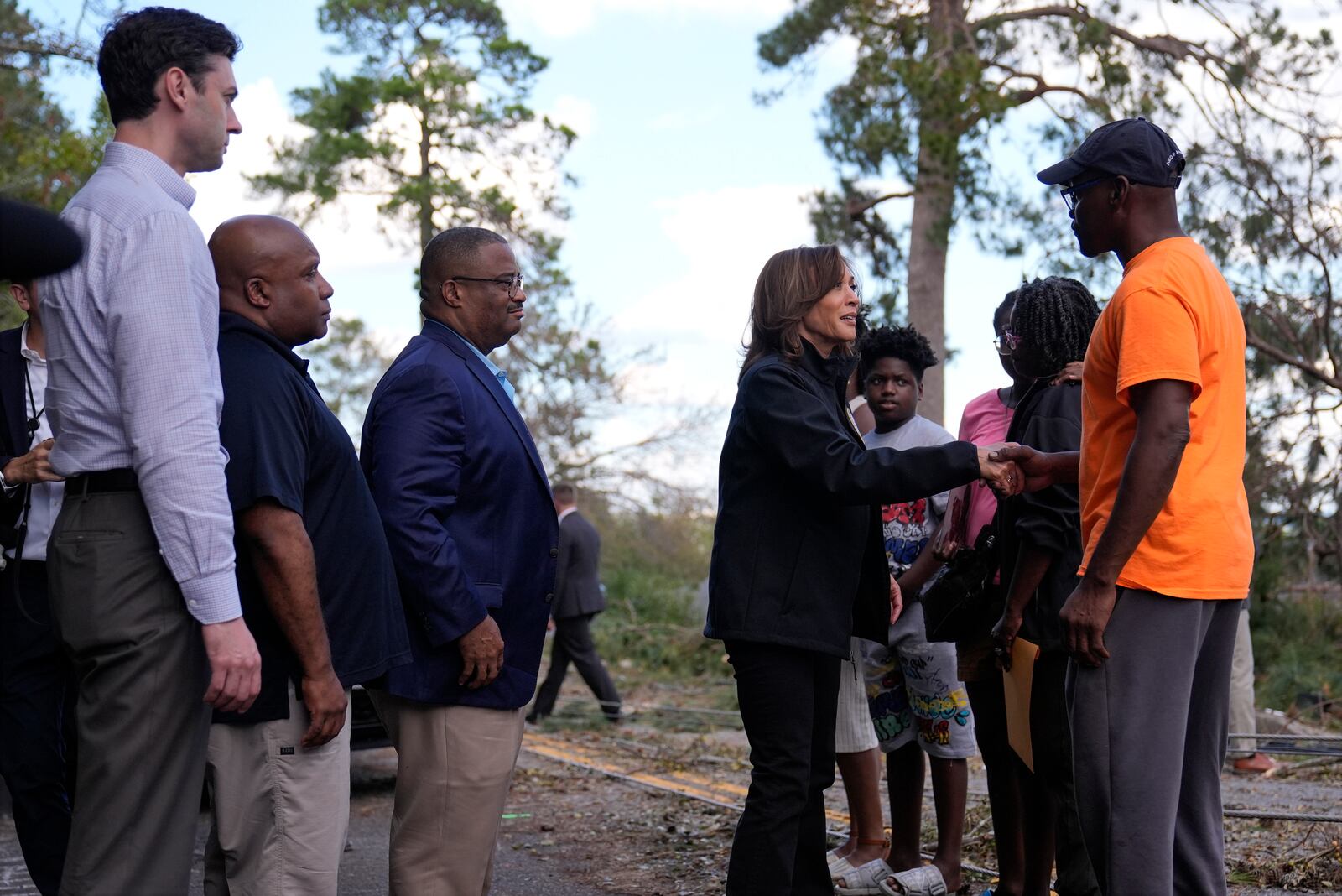 Democratic presidential nominee Vice President Kamala Harris greets people who were impacted by Hurricane Helene in Augusta, Ga., Wednesday, Oct. 2, 2024, as from left, Sen. Jon Ossoff, D-Ga., FEMA deputy direct Erik Hooks and Augusta Mayor Garnett Johnson watch. (AP Photo/Carolyn Kaster)