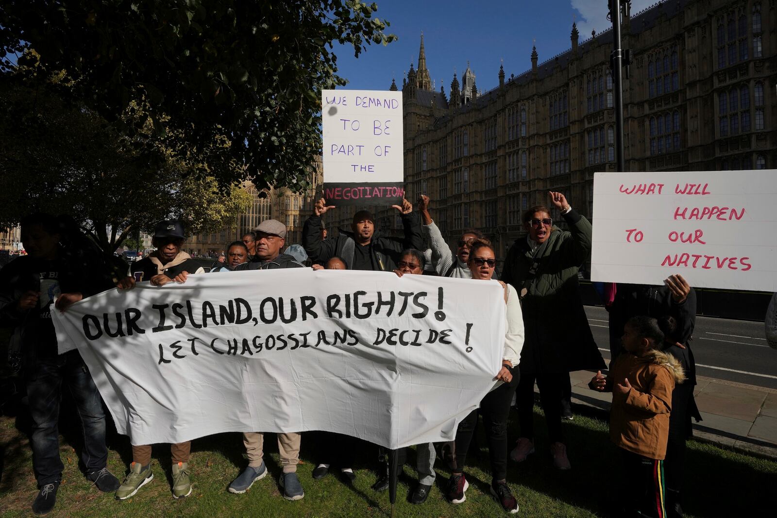 Chagossians attend a protest to respond to the U.K. announcement agreeing to hand sovereignty of the long-contested Chagos Islands to Mauritius and against their "Exclusion" from Chagos negotiations, outside the House of Parliament, in London, Monday, Oct. 7, 2024. (AP Photo/Kin Cheung)