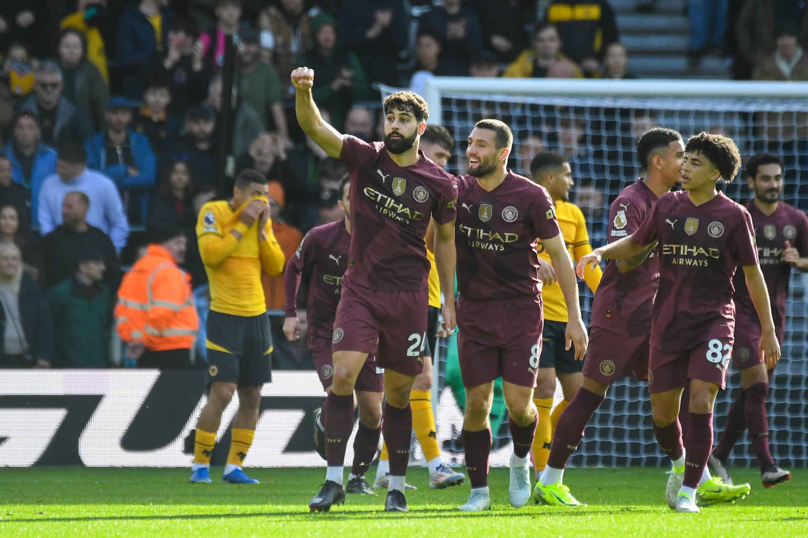 Manchester City's Josko Gvardiol, left, celebrates scoring his side's first goal during the English Premier League soccer match between Wolverhampton Wanderers and Manchester City at the Molineux Stadium in Wolverhampton, England, Sunday, Oct. 20, 2024. (AP Photo/Rui Vieira)