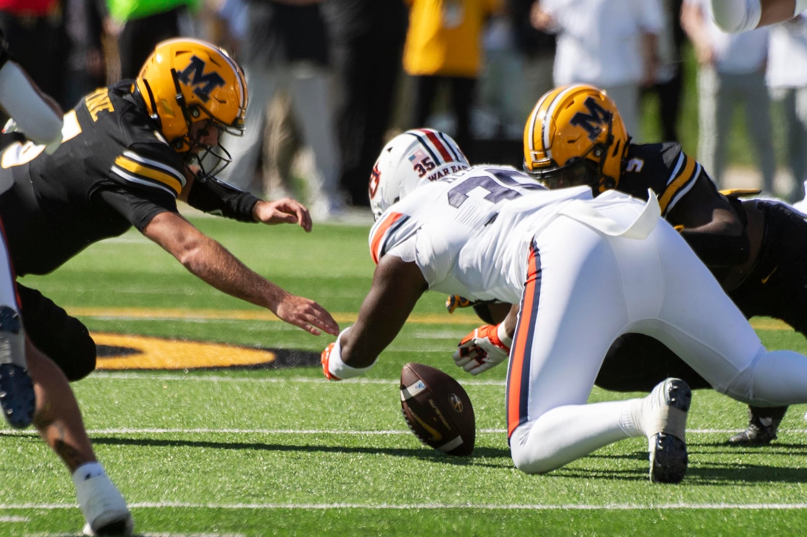 Missouri quarterback Drew Pyne, left, Luther Burden III, right, and Auburn's Jalen McLeodan chase on a fumble during the first half of an NCAA college football game Saturday, Oct. 19, 2024, in Columbia, Mo. (AP Photo/L.G. Patterson)