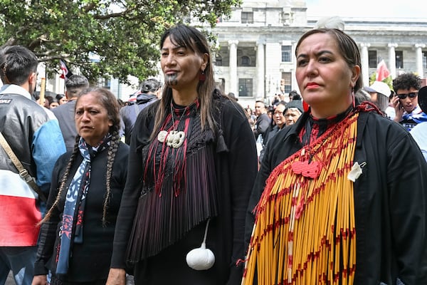 Members of Te Āti Awa, join thousands of people gathered outside New Zealand's parliament to protest a proposed law that would redefine the country's founding agreement between Indigenous Māori and the British Crown, in Wellington Tuesday, Nov. 19, 2024. (AP Photo/Mark Tantrum)